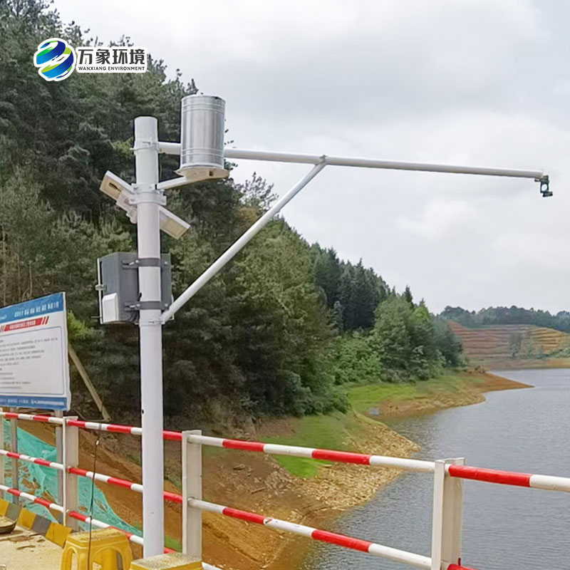 Why is the automatic monitoring system for water and rainfall conditions considered an essential tool for hydrological safety management during the rainy season?